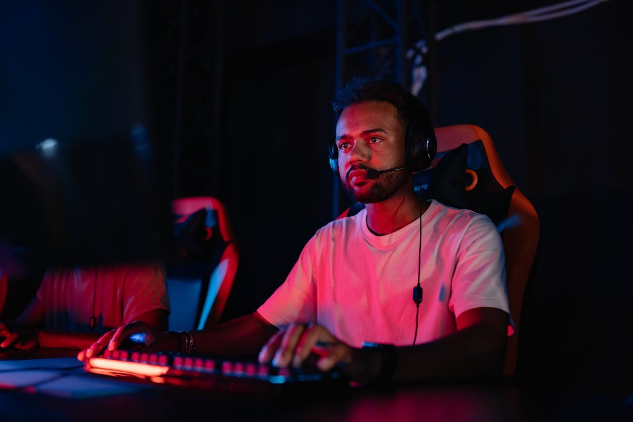 Man in a White Shirt Playing on a Computer