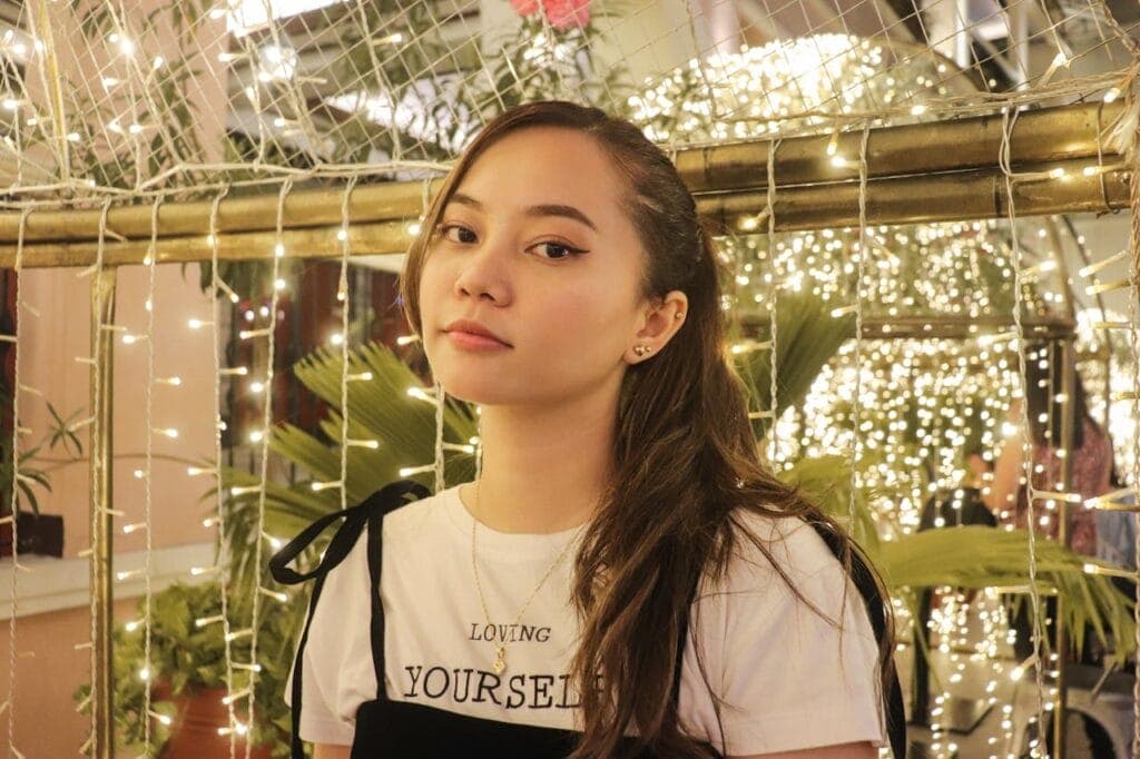 A Woman with Christmas Lights Background